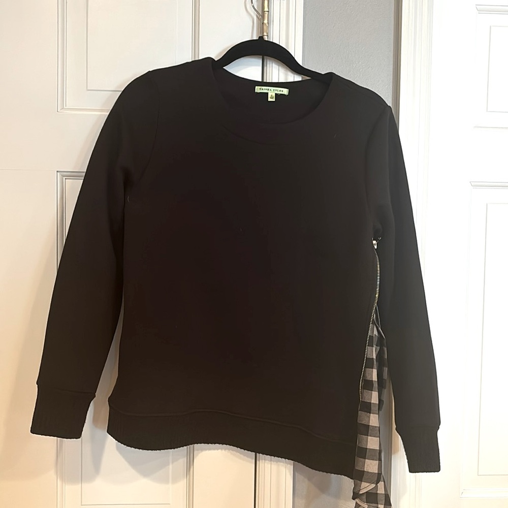 Trisha Tyler black sweatshirt with plaid side insert.